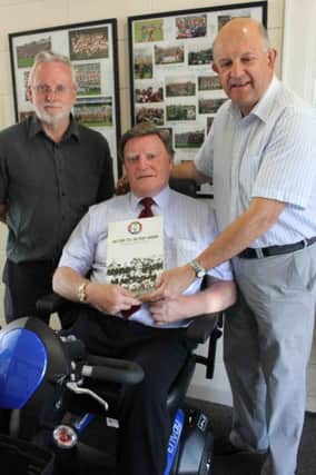 Brian Kneeland (centre), the first ever secretary of Eoghan Rua Gaelic Club receives a gift from Brendan McLernon (chairman) and Kevin Mullan (Secretary).