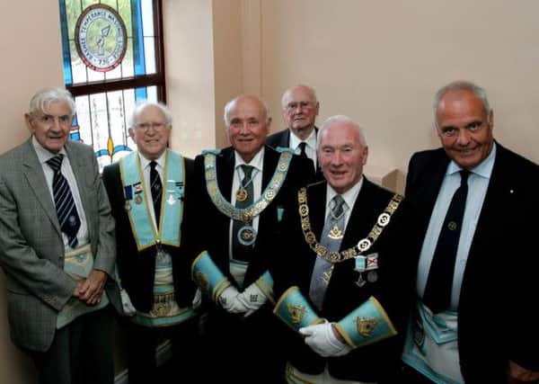 M.W. Bro George Dunlop (second from right) Grand Master, Grand Lodge of Ireland and Rt. W.Bro John Dickson, Provincial Grand Master, Provincial Grand Lodge of Antrim, pictured beside the stained glass window, which was gifted by Rashee Temperance Masonic Lodge, 736 to mark the bicentenary of Cogry Union Masonic Lodge No 148.  Representing their Lodge at the service of dedication were W.Bro Richmond McKay, Rt. Wor Bro Hugh Taggart, W.Bro David Montgomery and Bro Alan Munce. Pic by Pat McGuigan