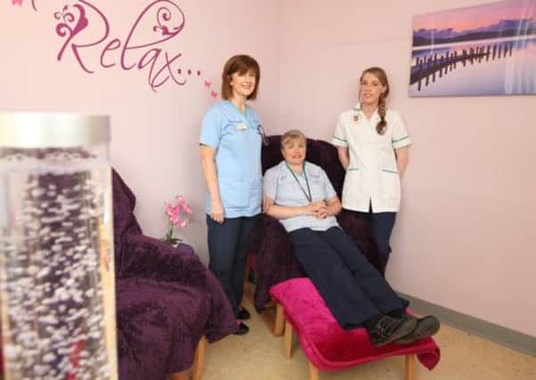 Health care worker Rosie Lennon, assisted by nurses Evelyn Brankin and Natasha Johnston, tries out the new sanctuary in the Psychiatry of Old Age department of Lagan Valley Hospital. The sanctuary offers a quiet place and calm surroundings where patients can relax. US1426-565cd Picture: Cliff Donaldson