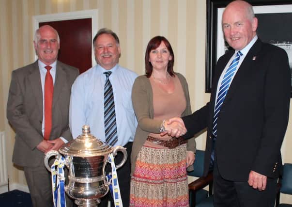 Leigh Livingstone is welcomed onto the Glenavon board by chairman Adrian Teer while Frazer Follis, treasurer and Trevor Harper, director look on.