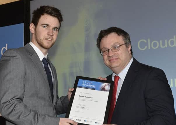 Employment and Learning Minister Dr Stephen Farry presents Denver McGavock from Broughshane with his graduation certificate at an awards ceremony following his graduation from the pilot Cloud Technology Academy.