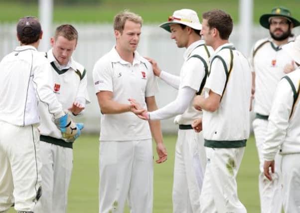 Lisburn players congratulate bowler Richard McConkey after Muckamore batsman Barry Scott is caught out, at Wallace Park. US1427-516cd Picture: Cliff Donaldson