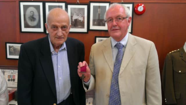 Robert Thompson and Leonard Quigg of the Robert Quigg VC Commemoration Society pictured with the actual Victoria Cross awarded to Robert Quigg. They are pictured at the official opening of Bushmills and The Great War centenary exhibition in Bushmills Community Centre. INBM28-14 UC