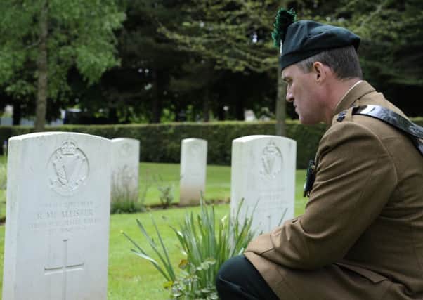 Lieutenant Colonel Owen Lyttle, of 2 Royal Irish, kneels at the graveside of Rifleman Ronald McAllister 2 RUR at Cambes-en-Plaine cemetery. Rifleman McAllister, from Belfast,served in D Company 2 RUR, and was killed on June 7 1944 at Cambes. He had two brothers killed and two others severely wounded. INNT 27-466-CON
