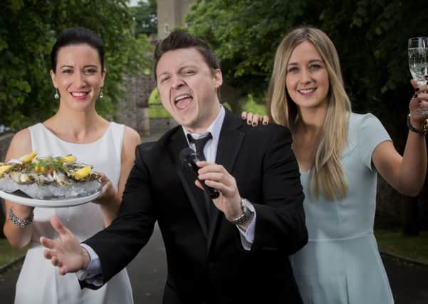 Crooner James Huish, one of the stars of the Pol Roger Hillsborough International Oyster Festival 2014, with Kerry Boyd (left), Autism NI Marketing Manager, and Rachel Gribben, Autism NI Marketing Assistant.