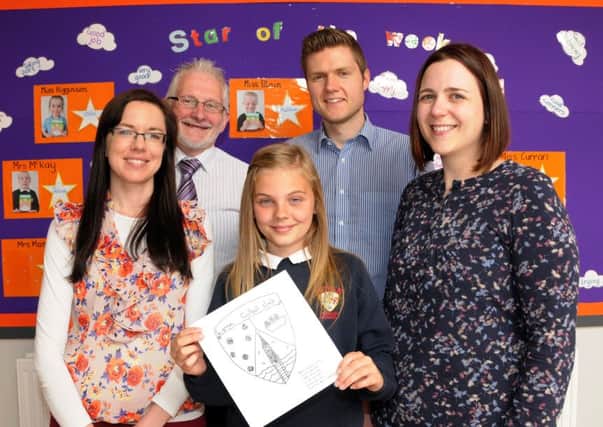 Moyle PS pupil Jamie Kleijn has won the competition to design a new club badge for Larne FC, marking the club's 125th anniversary. Pictured are teachers Miss Rea and Mrs Ford-Hutchinson and principal Mr Garrett with Ian Cahoon from Larne FC  INLT 27-231-AM