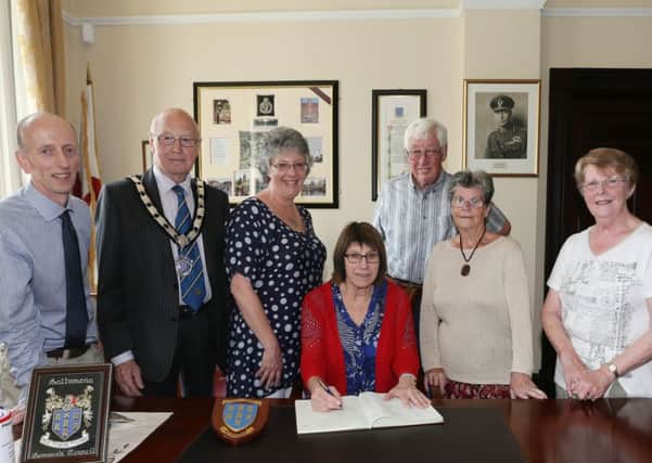 New Zealand visitor Ruth England, whose father Harry Lorrimer emigrated to New Zealand from Ballymena in the 1930s signs the visitors book at a reception in the Mayor's Parlour hosted by Deputy Mayor of Ballymena Cllr Hubert Nicholl. Also included are, L-R, Rev William Sinclair of 1st Ballymena Presbyterian Church, Sue Bridges from Christchurch, New Zealand plus Ruth's cousins Jean Clarke, Margaret McCrory and Ben Clarke. INBT 28-100JC