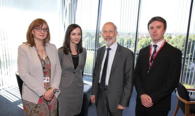 Justice minister David Ford with Marianne O'Kane, regional prosecutor, and staff from Lisburn's PPS office.  US1427-533cd Picure: Cliff Donaldson