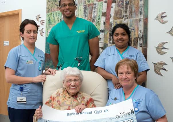 Moya Griffin is pictured in the Macmillan Unit, presenting cheque for £3600 on her 91st birthday, which was the proceeds of a barbecue at the Crosskeys Inn  in memory of Declan. Included are (back from left)
Paula McGilligan, Iheukwumere Duru, and Bisy Peter, (front from left) Moya Griffin & Sr Bernadette McWilliams.