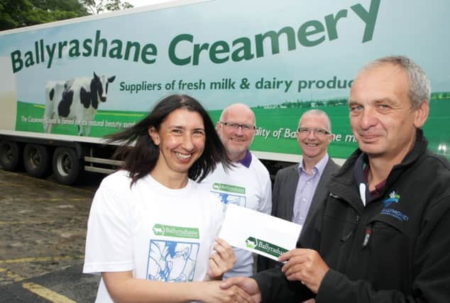 NICE CREAM. Emma Birrell, Company Secretary at Ballyrashane Creamery, who are the new sponsors of the Riada Fun Run, pictured on Thursday presenting a sponsorship cheque to Sports Development Manager John Fall with Kenny Bacon and Brian Edgar from the organising Committee, Springwell Running Club looking on.INBM27-14 060SC.