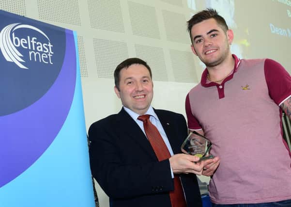 Dean McIlwaine, from Newtowanabbey, was recognised for his learning success at Belfast Met's annual Apprenticeship and Training Awards. He won the Apprentice in Barbering for his achievements and progress while completing his Level Three Barbering Apprenticeship. Dean is pictured receiving his award from Robin Swann MLA, chairman of the Employment and Learning Committee.  INNT 28-458-CON