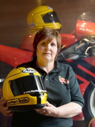 Linda Dunlop, the wife of the late Joey Dunlop, holds the new special edition Arai helmet that is painted in the colours Joey used in 1985.

PICTURE BY STEPHEN DAVISON