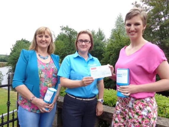 Gillian Clarke, Community Fundraiser Alzheimers Society receives £3550 cheque from Gemma Wylie and Daphne Wylie, raised through a sponsored head shave.