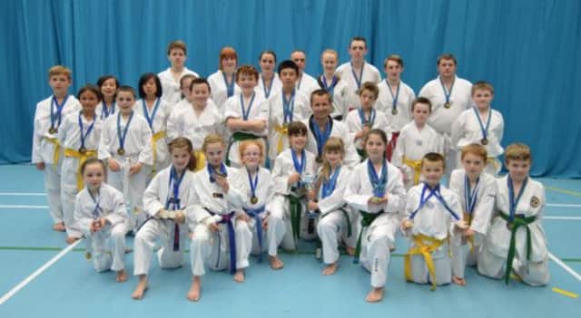 Lisburn Taekwondo Club players with their second place team trophy.