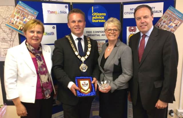Jacqui Dixon (left), chief executive of Antrim and Newtownabbey Council, Mayor Thomas Hogg and Nigel Dodds MP present Pat Hutchinson with some special mementos to mark her 30 years of service with Newtownabbey CAB. INNT 27-506CON
