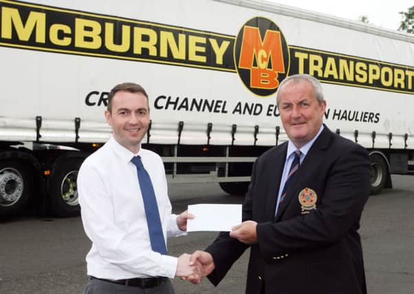 Philip McBurney, of McBurney Transport, presents a sponsorship cheque to Ballymena Golf Club captain David Small, for the club's open week. INBT28-200AC