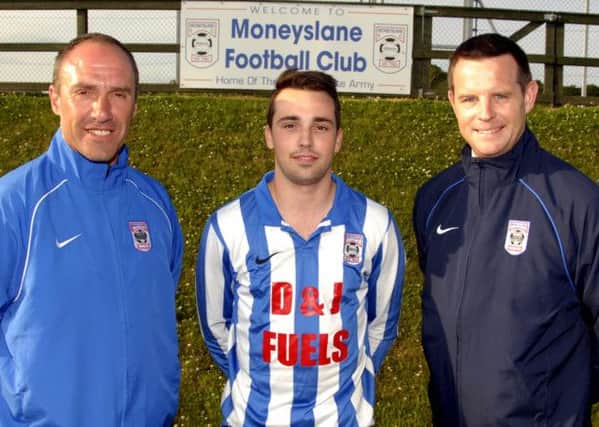 David Johnstone, First Team Manager and Assistant Manager Richard Graham, of Moneyslane Football Club, welcome new team signing Jonny Gibson. Photo: Gary Gardiner.  IN BL WK 2814-501.