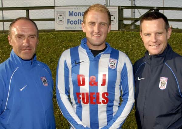 David Johnstone, First Team Manager and Assistant Manager Richard Graham, of Moneyslane Football Club, welcome new team signing Glenn Ferguson for the incoming 2013-2014 season.  Photo: Gary Gardiner. IN BL WK 2814-502.