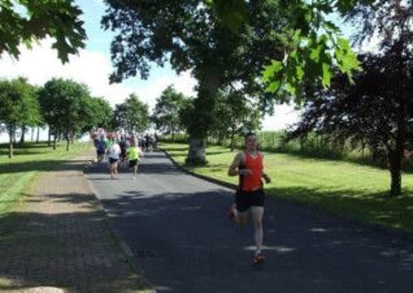 Gavin Corey leads the field in the MUSA Park Run enroute to setting a new course record