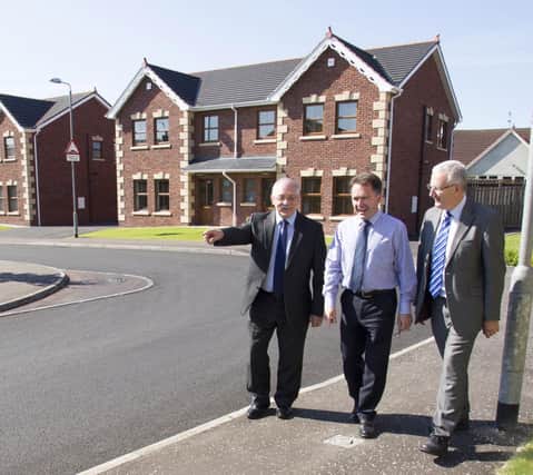 Regional Development Minister Danny Kennedy (right) has taken action to ensure that road works and utility services in a housing development left unfinished by developers facing financial difficulties will be completed using Road Bond funding. Pictured at Chestnut Hall, Maghaberry, with NI Waterâ¬"s Development Services Manager Frank Stewart (left) and DRD Transport NIâ¬"s Philip Robinson (centre).