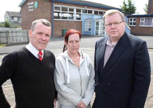 Jim McLaughlin and Andrina Brady, from Derriaghy Village Community Association, with Jonathan Craig MLA at the former Derriaghy Primary School which has been targeted by vandals breaking in and causing damage in the grounds.  US1428-539cd Picture: Cliff Donaldson