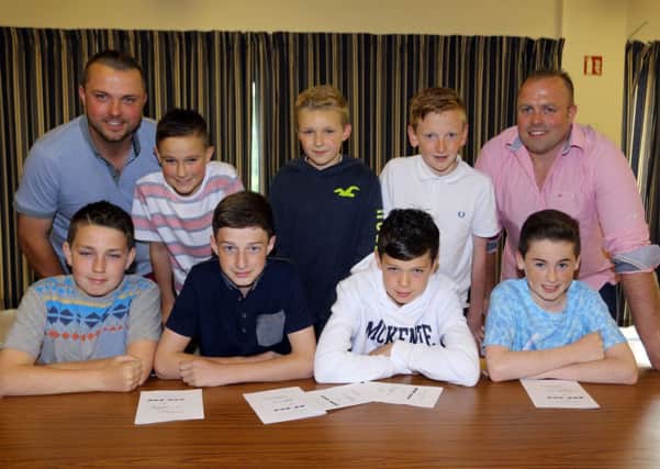 Sammy Hill and David Parker (coaches) with members of the Carniny Youth U-13 team at their recent fund raising night at the races. INBT27-248AC