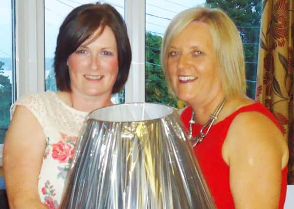 Cairndhu Lady Captain Lyn Morrow presents competition winner Sinead Robinson with her prize. INLT 28-923-CON