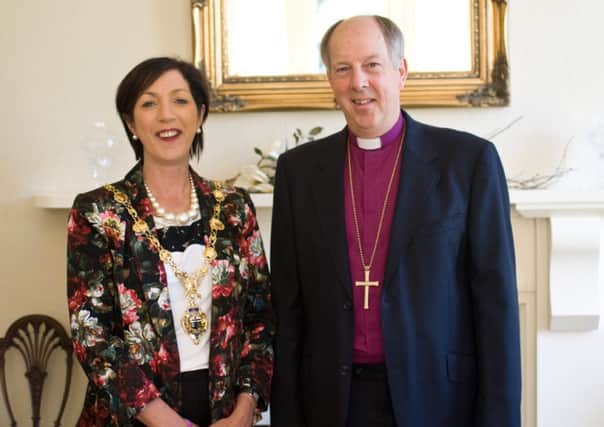 Bishop Ken Good welcomes the mayor, Brenda Stevenson, to See House.