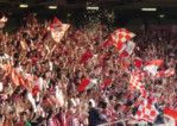 Derry City fans in full cry at the Brandywell.