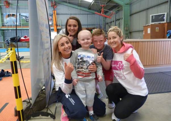 Leukaemia sufferer Ross Patterson with big brother Jack and skydivers  Chelsea Kirk, Chloe McAllister and Anita Knox, who raised over £1,300 for cancer charities. INNT-29-700-con