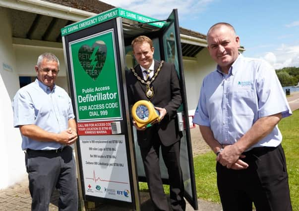 Mayor of Craigavon Councillor Colin McCusker with the new publicly accessible defibrillator at Kinnego Marina. Looking on is Harbour Master Paddy Prunty and Assisant Harbour Master Paul Magee.