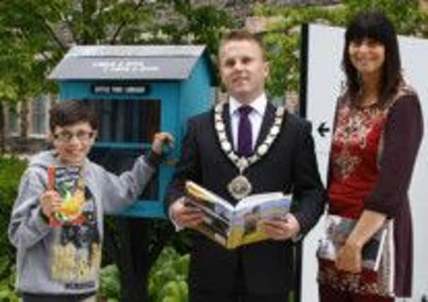 Liam Nachmias (11) borrows a book from one of the new Bookstops launched by the Mayor, Alderman Thomas Hogg and Ursula Fay from Newtownabbey Borough Council. The Bookstops are currently located at the Civic Square, Mossley Mill and on the Newtownabbey Way. INNT 29-501CON