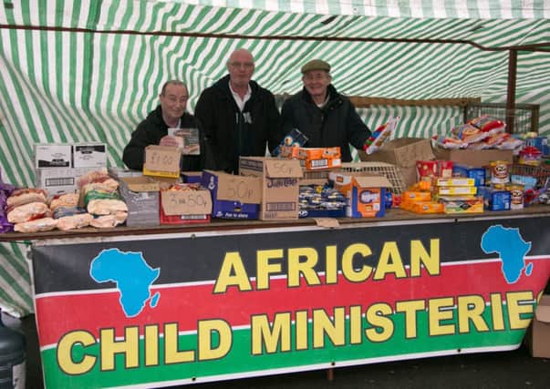 Bobby Devine, Dessie Burns and Tony Jones pictured at their African Child Ministeries stall which is held every Saturday in the Church of Ireland car park in Greenisland (file photo).