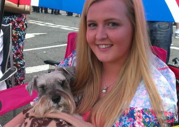 Kirsty Lynn from Magherafelt, with Murphy, sheltering from the rain in Limavady. Photo: Olga Bradshaw