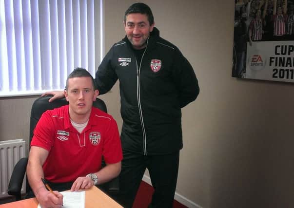 Derry City goalkeeper, Ciaran Gallagher, signs a one year contract with the Brandywell club. Included is Derry City manager, Peter Hutton.