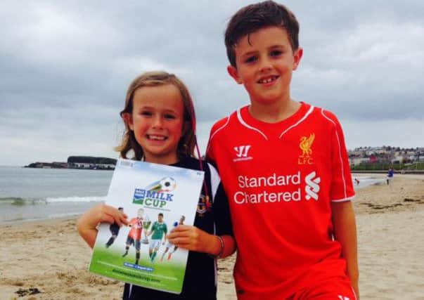 Ben and Rebecca Andrews with the first copy of the Dale Farm Milk Cup programme which is now on sale.
