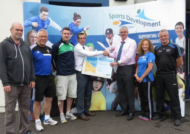 Ollie Mullan, Sports Development Officer is pictured receiving the Quest plaque from Barry Toorish, Leisure Services Manager. Also pictured is, (l-r): Mark Cummings, Caretaker, Joe Doherty, IFA Grass Roots Development Officer, Gerald Gillan and Nicola Taylor, Active Communities Coaches and Richard Ferris, Gaelic Games Development Officer.