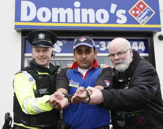 Davy Boyle (The Caring Caretaker) and Constable Darren Pollock (PSNI) arresting Joggy Dhillon for the Jail and Bail fundraising event.