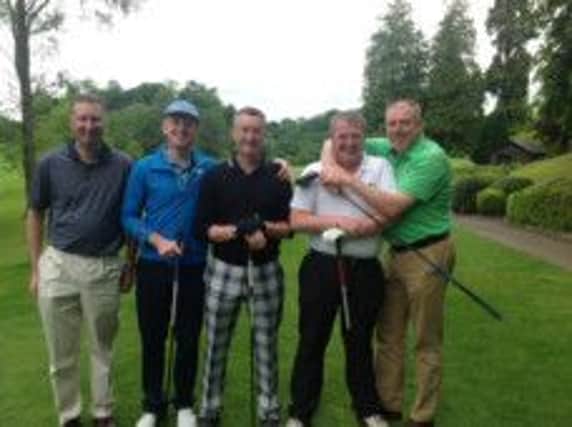 Darryl Flannagan, second right, being embraced by Neil Greaves, won the Max McCready Salver with a net 62.