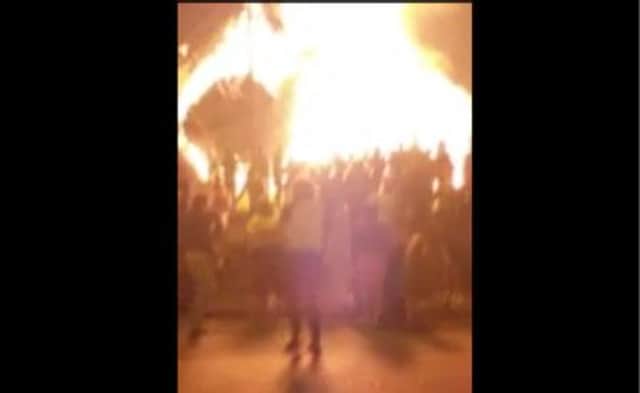The Ballymacash bonfire as it topples over.