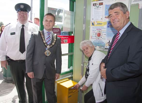 PSNI Sector Inspector Stephen McGuigan, Mayor Thomas Hogg, local resident Annie Anderson and Neighbourhood Renewal Partnership chairman Councillor Billy Webb check out the new drug disposal bin located in the Spar store at The Diamond. INNT 30-451-CON