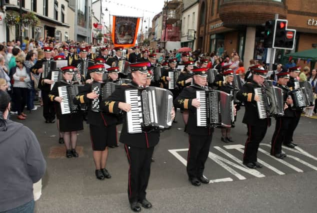 ON THE BUTTON. Members of Dunloy Acc Band move onto Meetinghouse St on Saturday.INBM29-14 010SC.