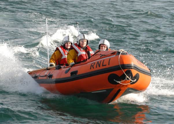 Pamela Dorman, Catherine Callghan and Scott Leitch head back to Larne Harbour onboard the inshore lifeboat. INLT 09-321-PR