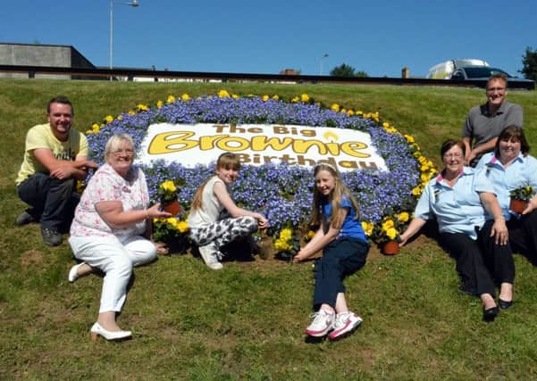 Cllr. Beth Adger is pictured along with Brownies Naomi Nevin and Kathryn Peachey, Leaders Sadie Peachey and Suzie Foster, applying the finishing touches to the Brownies 100th Birthday Flower Bed on the Larne Road Link. Included are Noel Robinson (Ballymena Borough Council Ground Maintenance Supervisor) and Andrew Clarke (gardener). INBT30-200AC