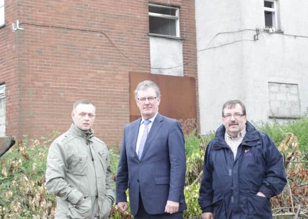UUP leader Mike Nesbitt and Cllr John Scott with NACN Chair David Crooks (left) in front of the derelict flats on Glenbane Avenue.