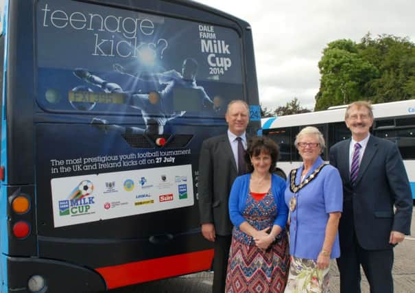 Mayor of Ballymena, Cllr. Audrey Wales, is pictured with Victor Leonard (Dale Farm Milk Cup official(, Brigid Black (Sports Facilities Manager) and Robin McAleese (Translink) beside one of the Dale Farm Milk Cup adverts appearing on Translink buses. INBT27-212AC