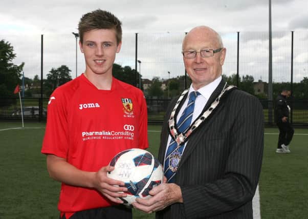 Josh Corry, from Ballymena, a member of the Co. Antrim Milk Cup U-18 squad, is pictured with Deputy Mayor of Ballymena, Cllr. Hubert Nicholl. INBT28-246AC