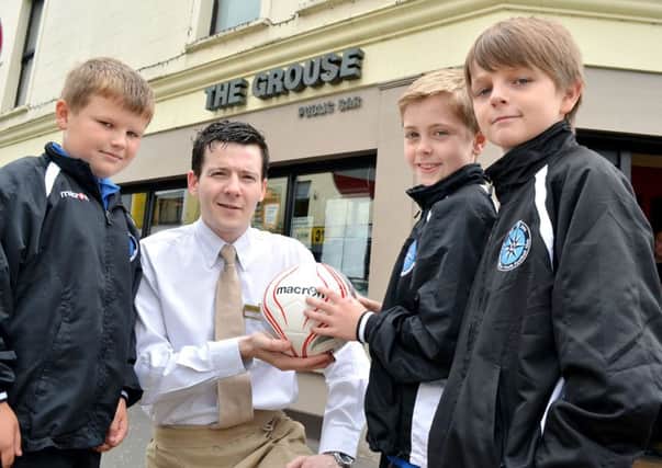 Owen, Lewis and Jack of Northend United recieve a match ball as part sponsorship from Ken Crabbe of the Grouse Inn, Ballymena; for their forthcoming Foyle Cup campaign. INBT 30-808H