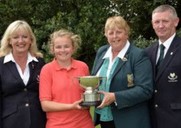 Annabel Wilson receives her winners All Ireland trophy from Mary Carroll Lady Captain, Shannon Golf Club, Mary McKenna President ILGU and Karl Moloney Captain, Shannon Golf Club.
