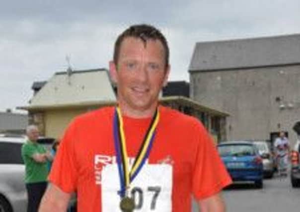 Jonathan O'Hagan of Barn Runners with his medal.